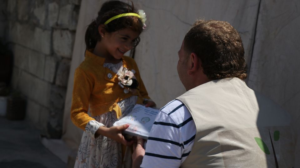 young girl receiving qurbani donations